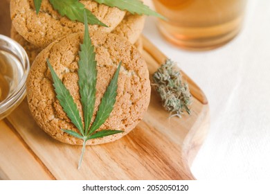 Delicious homemade cookies with CBD cannabis and leaf garnish. Medicinal Edibles. Treatment of medical marijuana for use in food. Canada legalization. Rasta cookies. High quality photo