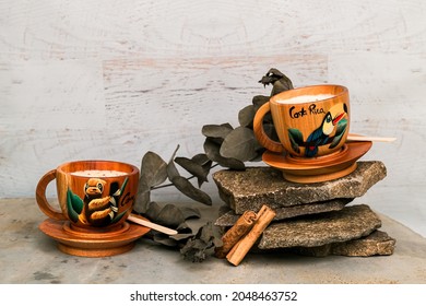 Delicious homemade eggnog served up in wooden cups with sprigs of eucalyptus leaves and cinnamon sticks for decoration.