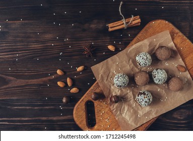Delicious homemade energy balls with dried apricots, dates, prunes, walnuts, almonds and cashews in sesame seeds and cocoa. Vegan and vegetarian raw appetizer or food. The view from the top. Copy spac - Shutterstock ID 1712245498