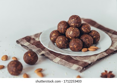 Delicious homemade energy balls with dried apricots, dates, prunes, walnuts, almonds and cashews in cocoa. Vegan and vegetarian raw appetizer or food. Side view on a white background.  - Shutterstock ID 1712253403