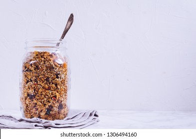 Delicious homemade granola in glass jar on white background. Breakfast. Healthy food sweet dessert snack. Diet nutrition concept. Vegetarian food. Copy space. - Powered by Shutterstock