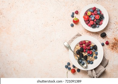 delicious homemade granola or oatmeal with berries for breakfast over white background, top view with copy space - Shutterstock ID 721091389