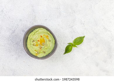 Delicious Homemade Green Hummus In A Small Bowl.