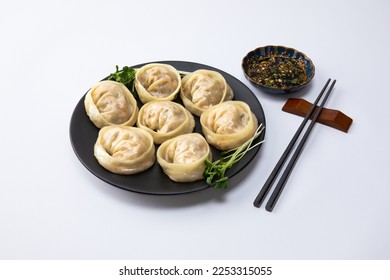 Delicious homemade Korean kimchi dumplings and sauce, white background - Shutterstock ID 2253315055