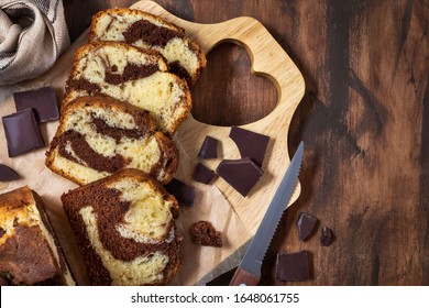 Delicious homemade marble pound cake on wooden background, top view