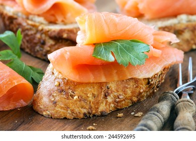 Delicious homemade smoked salmon canape garnished with a fresh parsley leaf