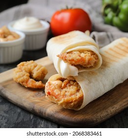 A Delicious Homemade Spicy Shrimp Wrap Sandwich With Lettuce, Tomato, And Tartar Sauce.
