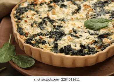 Delicious homemade spinach quiche on wooden board, closeup - Powered by Shutterstock