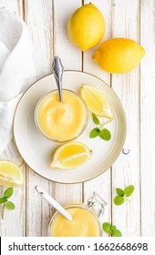 Delicious Homemade Tangy Lemon Curd Decorated With Fresh Fruit In A Glass Jars On Rustic Wooden Background