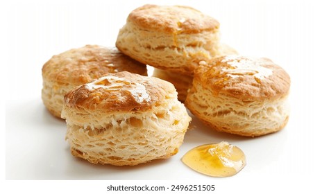 A delicious honey scone rests on a pristine white background, its golden-brown crust glistening with a light glaze of honey. The scone's flaky texture and sweet aroma invite indulgence, making it a pe