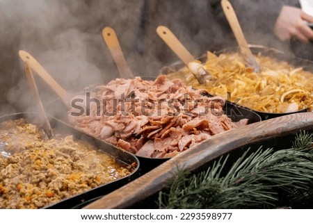 Delicious hot dishes outdoors traditional festive market catering service, food preparation, cooking and serving hot steamy food, tasty, delicious meals, variety of different foods, outdoors, closeup