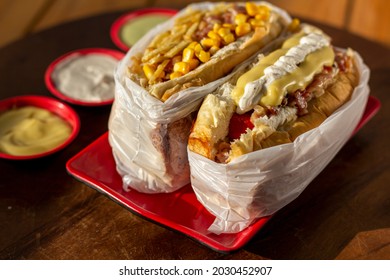 Delicious hot dog with ingredients and on colorful or wooden background.