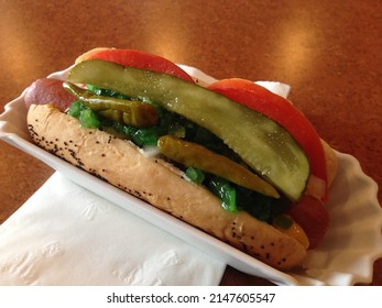 The Delicious Hot Dog Is Served On A Paper Plate. Fast Food Concept. 