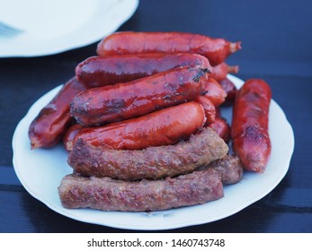 Delicious Hot dogs, sausages, wieners are in a white plate on a dark table. Family picnic  is on Sunday. - Powered by Shutterstock