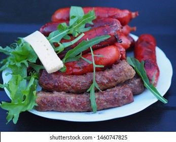 Delicious Hot dogs, sausages, wieners , cheese , spicy herbs are in a white plate on a dark table.   Family picnic  is on Sunday. - Powered by Shutterstock