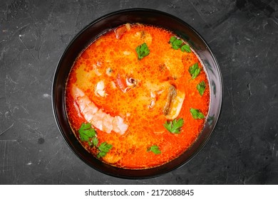 delicious hot traditional tom yam soup on a black background.