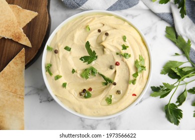 Delicious Hummus With Parsley And Pita Chips On White Marble Table, Flat Lay