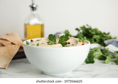 Delicious Hummus With Parsley And Pita Chips On White Marble Table, Closeup