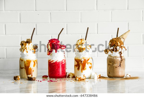 Delicious ice cream float, vanilla,\
strawberry, coffee, chocolate and white wall\
background