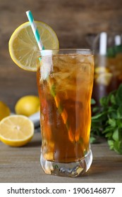 Delicious Iced Tea In Glass On Wooden Table, Closeup