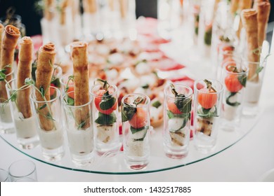 Delicious Italian Food Table At Wedding Reception. Tomatoes, Basil,cheese,prosciutto, Greenery And Bread Appetizers On Table At Wedding Or Christmas Feast. Luxury Catering Concept