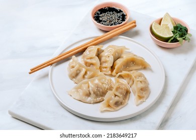 Delicious Japanese gyoza dumplings steamed  on a white plate with soy sauce. Takeout  food - Powered by Shutterstock