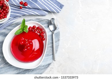 Delicious jelly with berries and mint on grey table, flat lay. Space for text