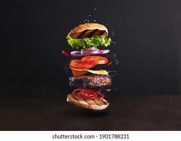 Delicious, juicy burger layers over a dark background