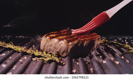 Delicious Juicy Meat Steak Cooking On Grill. Silicone Cooking Brush. Aged Prime Rare Roast Grilling Fresh Marble Tenderness Beef. Prime Beef Fry On Electric Roaster, Rosemary Black Pepper Oil.