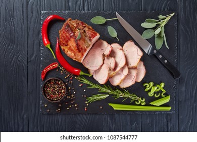 Delicious Juicy Roast Piece Of Pork Meat Cut In Slices On A Black Slate Tray, View From Above, Flatlay