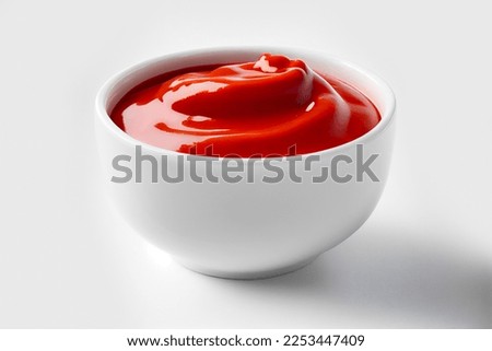 Delicious ketchup in white bowl isolated on white background. Portion of tomato sauce with clipping path. Collection of various sauces
