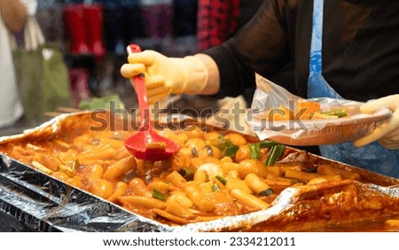 Delicious Korean cuisine Tteokbokki, tasty spicy rice cake with sausages, eggs in market for street food snacks.