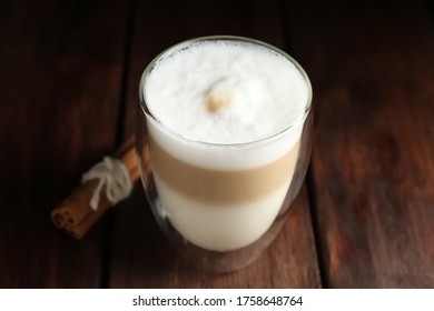 Delicious Latte Macchiato And Cinnamon On Wooden Table