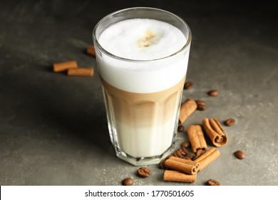 Delicious Latte Macchiato And Cinnamon On Grey Table