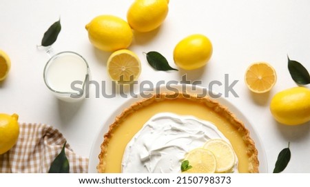 Delicious lemon tart with milk on light background