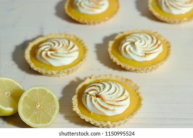 Delicious lemon tartlets with meringue on a white vintage plate. - Shutterstock ID 1150995524