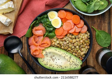 Delicious Lentil Bowl With Carrot, Avocado, Egg And Salmon On Wooden Table, Flat Lay