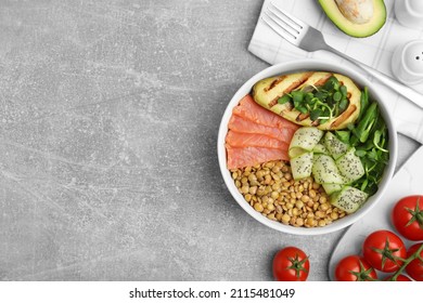 Delicious Lentil Bowl With Salmon, Avocado And Cucumber On Grey Table, Flat Lay. Space For Text