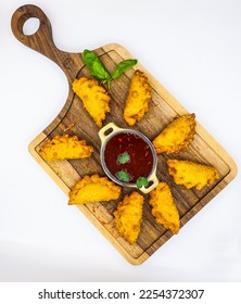 delicious little cheburekis on a wooden tray with sauce - Shutterstock ID 2254372307