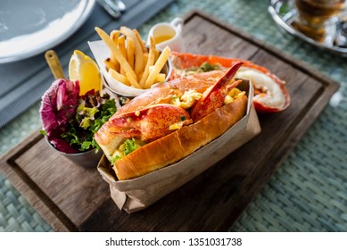 Delicious Lobster Roll Sandwich Served With A Side Of French Fries And Fresh Salad. New England Lobster Roll