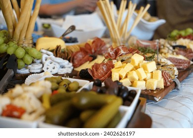 A delicious looking charcuterie board with a variety of gourmet cheeses, meats, and olives