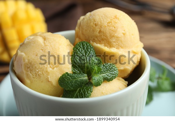 Delicious mango
ice cream in bowl on table,
closeup