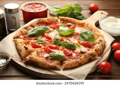 Delicious Margherita pizza and ingredients on wooden table - Powered by Shutterstock