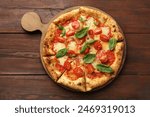 Delicious Margherita pizza on wooden table, top view