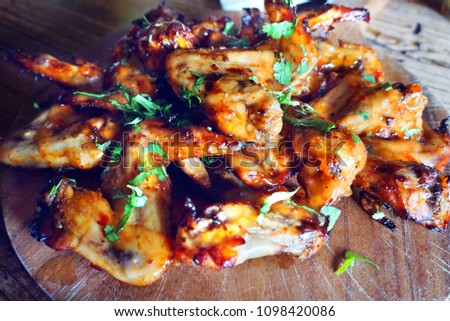 Delicious marinade spicy chicken wings with herbs
