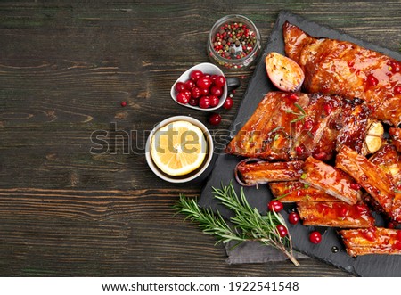 Delicious marinated grilled barbecue spare ribs with different sauces. Homemade food concept. Top view, copy space
