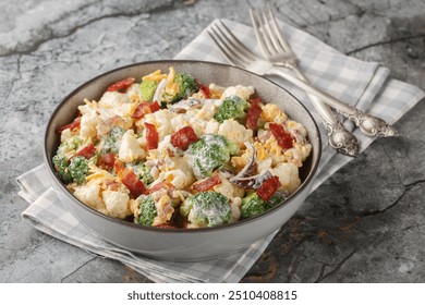 Delicious mayonnaise salad with broccoli, cauliflower, bacon, cheddar cheese and red onion close-up in a bowl on the table. Horizontal
 - Powered by Shutterstock