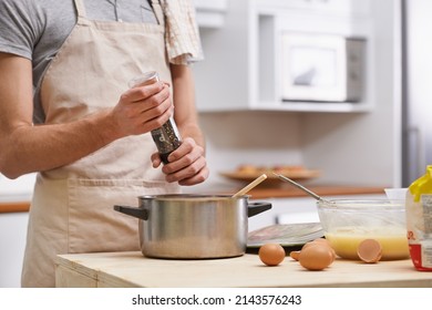 Delicious Meal In The Making. Cropped Shot Of A Young Man Cooking In The Kitchen.