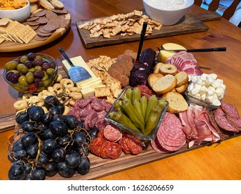 Delicious meat and cheese tray. Charcuterie tray full of fruits, olives, meats, cheeses, and okra.