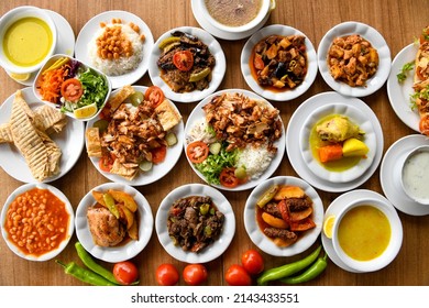 Delicious meat kebab with fresh vegetable salad served with variety of Turkish dishes and appetizers. Top view of assorted Turkish food and meze, tasty and healthy Mediterranean cuisine. - Shutterstock ID 2143433551